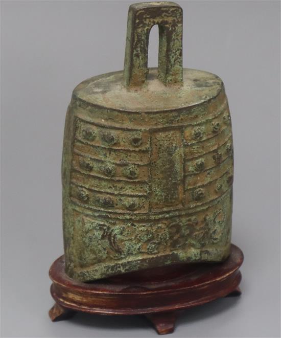 An archaistic bronze temple bell, on wooden stand overall height 15cm